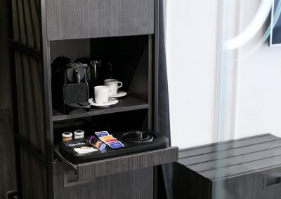 Detail of built-in hotel wardrobe in dark Nordic wood