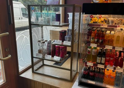 detail on the cabinet made of tahogany and glass shelves